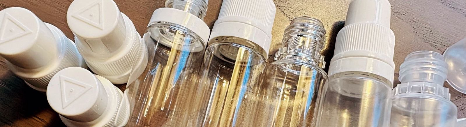 Butelki na e-liquid z zakraplaczami i zakrętkami zabezpieczonymi przed dziećmi